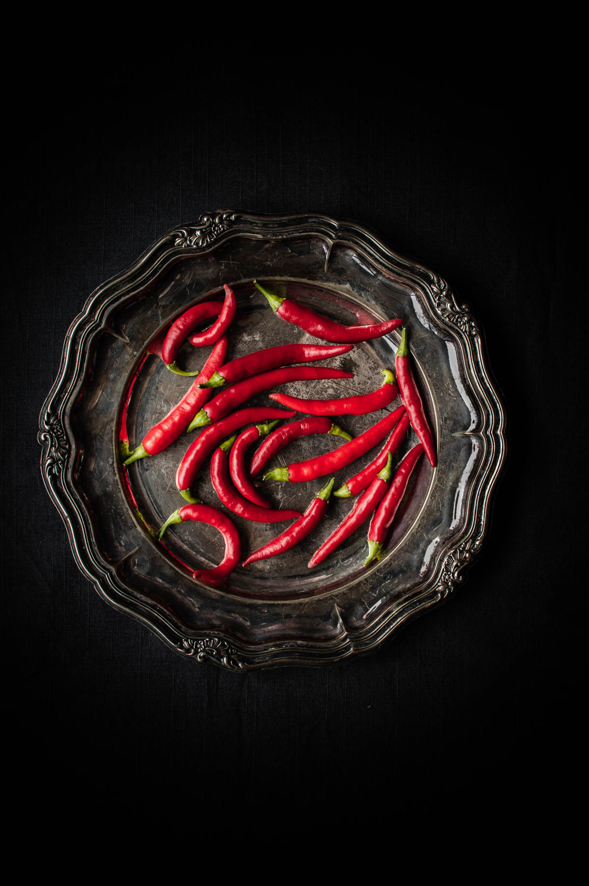Red chilies on a silver plate.